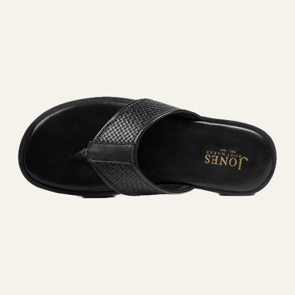 Woven Thong — Hand-woven vamp on a cushioned platform.